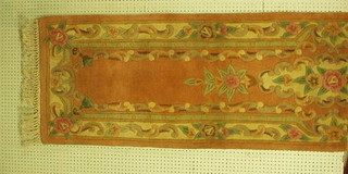 A peach ground and floral patterned Chinese runner 120" x 27"