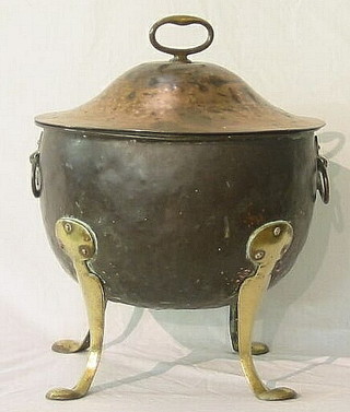 A circular Art Nouveau lidded copper coal bucket raised on brass cabriole supports 16"