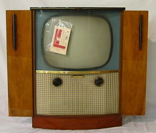 A 1960's 21" Majestic Luxury television with VHF radio, model number QF80 together with original bill of sale for 110 guineas and instruction manual, contained in a walnutwood finished case