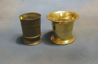 An 18th Century pewter beaker 4" the base engraved and a 17th/18th Century brass mortar 4"