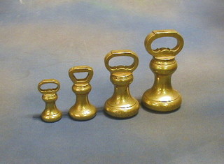 A set of 4 brass bell weights