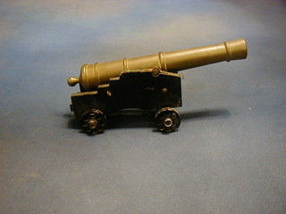 A brass model of a Gibraltar pattern 24lbs  cannon with 10" brass barrel, raised on a wooden trunion