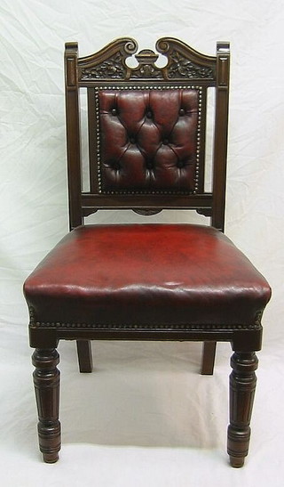 A set of 4 Victorian carved walnutwood dining chairs with red leather upholstered seats and backs,