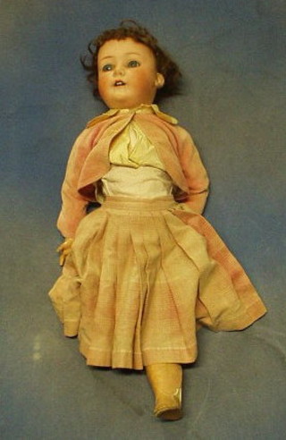 A 19th Century Heubach Koppelsdorf porcelain headed doll with open eyes and open mouth with head incised Heubach.Koppelsdorf 215.4 Germany