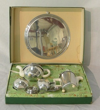 A childs Kalvin  5 piece tea service comprising tray, hotwater jug, teapot, sugar bowl, tea strainer and cup