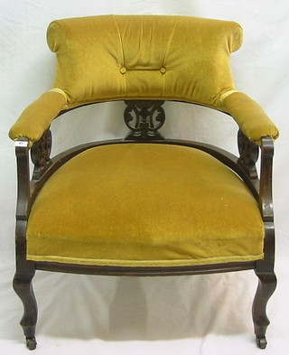 A Victorian mahogany tub back chair with pierced decoration upholstered yellow material