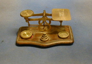 A pair of postage scales with brass weights