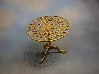 A circular pierced brass trivet decorated a horse 8"