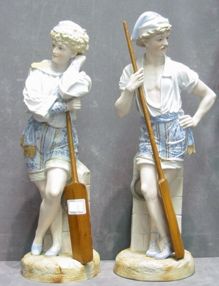 A pair of 19th Century biscuit porcelain figures of standing oarsmen 16"
