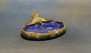 A Doulton Lambeth oval salt glazed ashtray decorated a diving bird, the base marked 8728, 6"