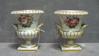A pair of 19th Century porcelain twin handled urns of campanular form with gilt banding and floral decoration, 5" (1 handle r)
