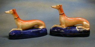 A pair of 19th Century Staffordshire pen rests in the form of seated grey hounds 8"