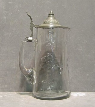 A glass jug with hinged pewter lid