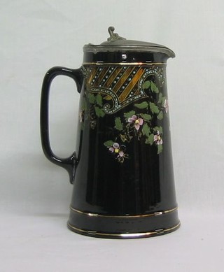 A Victorian jet ware jug with pewter mounts (base cracked) 8"