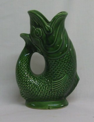 A Dartmouth pottery green glazed gurgling fish jug 7" and a green glazed jug decorated Chrysanthemums 6" (2)