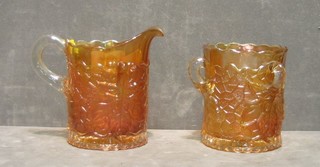 An orange Carnival vase jug with clear glass handle and a circular vase 4"