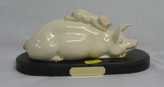 A pottery figure of 2 reclining pigs "Piggy Back"