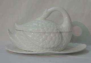 A white glazed pottery soup tureen stand in the form of a seated swan