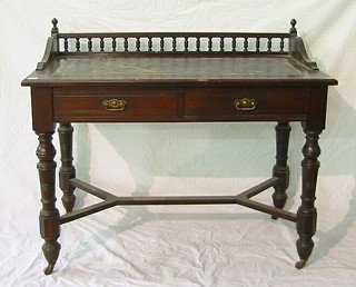 A Victorian mahogany writing table with bobbin turned three-quarter gallery, inset a tooled leather writing surface, above 2 short drawers with Y framed stretcher, raised on turned supports 42"