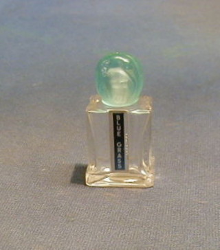 A French glass scent bottle with blue glass stopper decorated jungle animals, the base marked Made in France for Blue Grass perfume