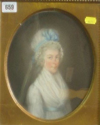 An 18th Century gouache portrait "Bonnetted Lady" 9" oval contained in a gilt frame