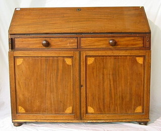 A Georgian inlaid mahogany "House Keeper's" bureau with fall front revealing a fitted interior, the base with 2 short drawers above a double cupboard, fitted trays 48"