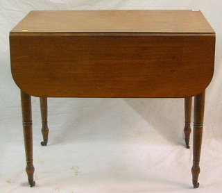 A Victorian mahogany Pembroke table fitted a drawer, raised on ring turned supports ending in brass caps and castors 33"