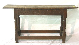 An 18th Century oak bench of joyned construction, raised on turned and block supports, 44"