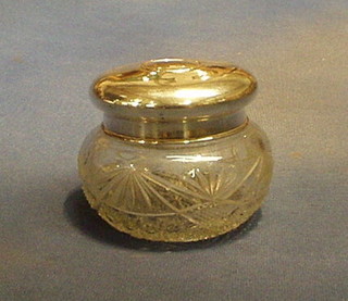 A cut glass dressing table jar with silver coloured lid