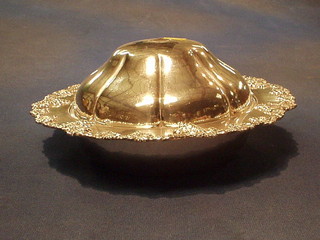 A silver plated muffin dish with vinery decoration