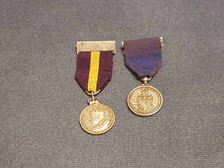 A George V silver Royal Warrant Holders Association medal and a Worshipful Company of Musicians silver medal