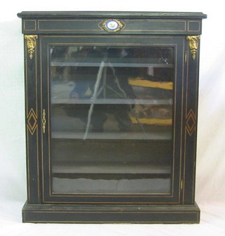 A 19th Century ebonised Pier cabinet, inlaid satinwood stringing, the interior fitted shelves enclosed by a glazed panelled door, 35"