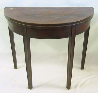 A Georgian mahogany card table with crossbanded top, raised on square tapering supports 34"