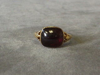 A gold dress ring set a cabouchon cut garnet