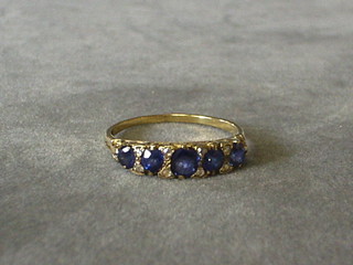 A lady's gold dress ring set 5 sapphires and 8 diamonds