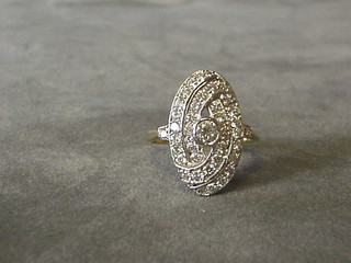 A lady's gold dress ring with swirl decoration set a central diamond surrounded by numerous diamonds (approx 0.85ct)