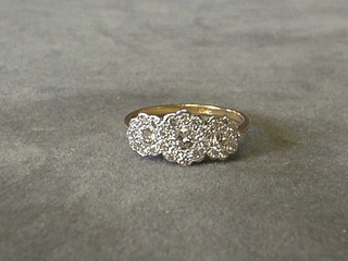 A lady's gold dress ring 3 large diamonds surrounded by diamonds