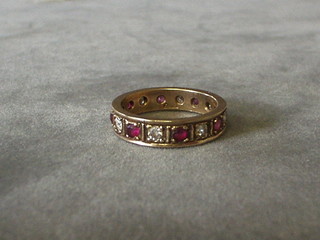 A lady's 9ct gold eternity ring set garnets and diamonds