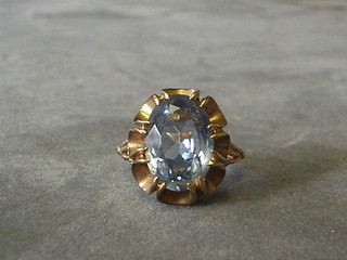 A lady's 9ct gold dress ring set a blue stone