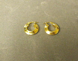 A pair of gold hoop earrings