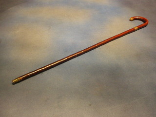 A walking stick with gold band