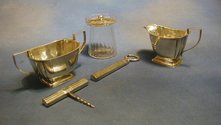 A cut glass preserve jar with silver plated top, a silver plated twin handled sugar bowl, cream jug, do. cork screw and bottle opener