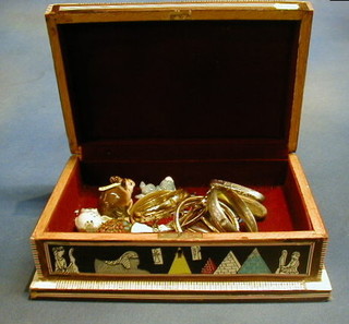 An Eastern trinket box decorated Chariot scene containing a silver bangle, an amber and gilt mounted cigar holder, various bangles, a silver charm bracelet and a collection of miniature figures