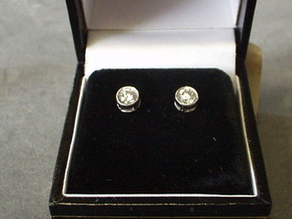 A pair of lady's diamond stud earrings (approx. 0.67)