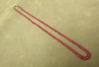 A string of red hardstone beads 19"