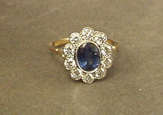 A lady's gold dress ring set a sapphire surrounded by 10 diamonds approx 1.53/0.95ct