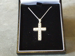 A lady's white gold cross set diamonds, hung on a white gold chain