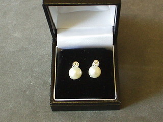 A pair of lady's pearl and diamond earrings