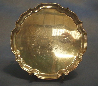 A silver salver with bracketed border Birmingham 1970 raised on 4 scroll supports, 12", 24 ozs