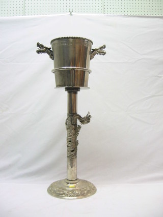 An Oriental Eastern silver plated twin handled wine cooler with dragon handles, raised on a silver plated stand